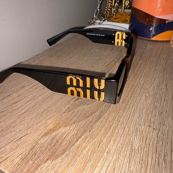 Miu Miu Black Sunglasses with Gold Detailing